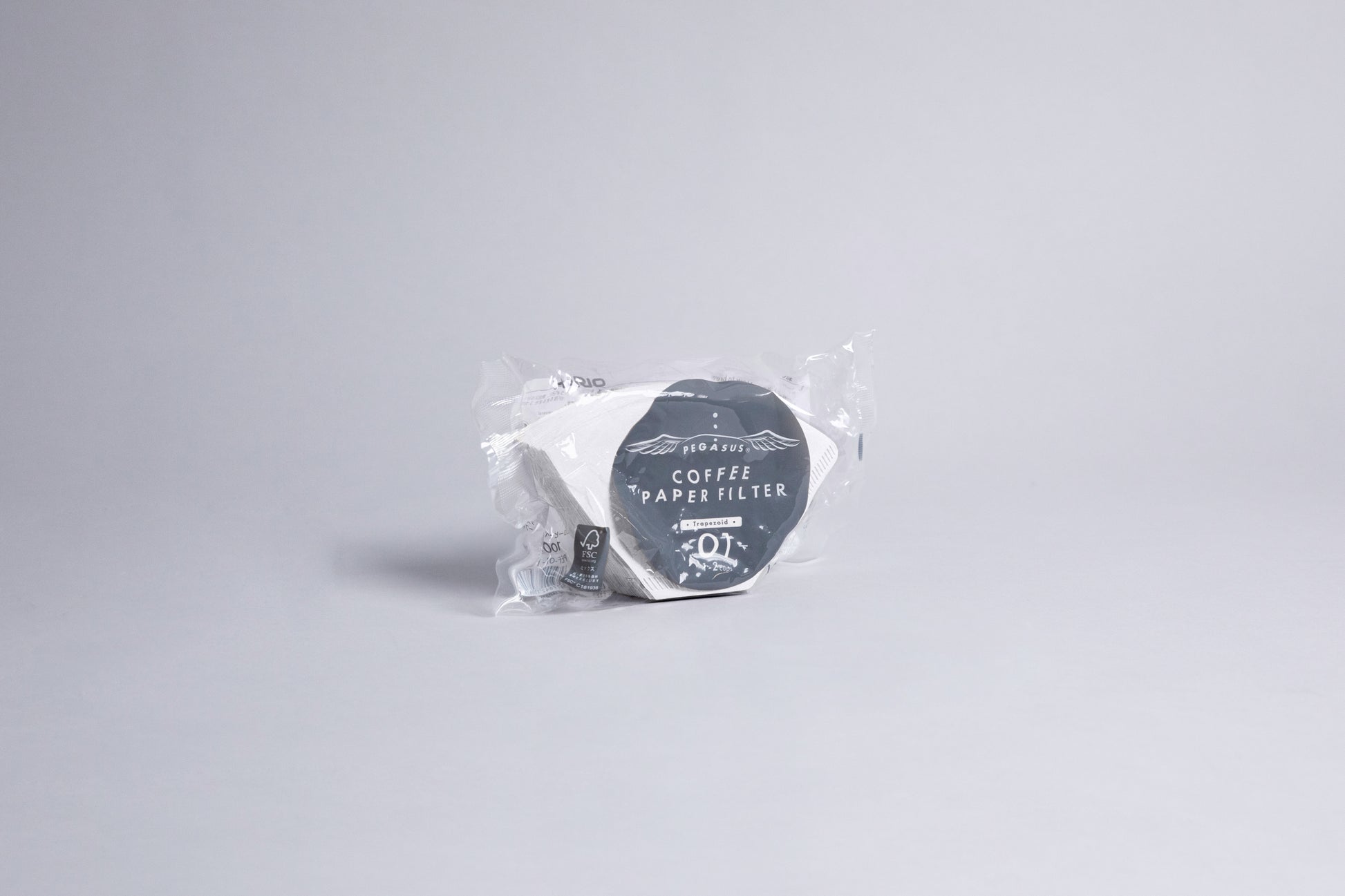 White flat bottom cone shaped paper filters in plastic bag with gray and white accents label. set against a light gray background.