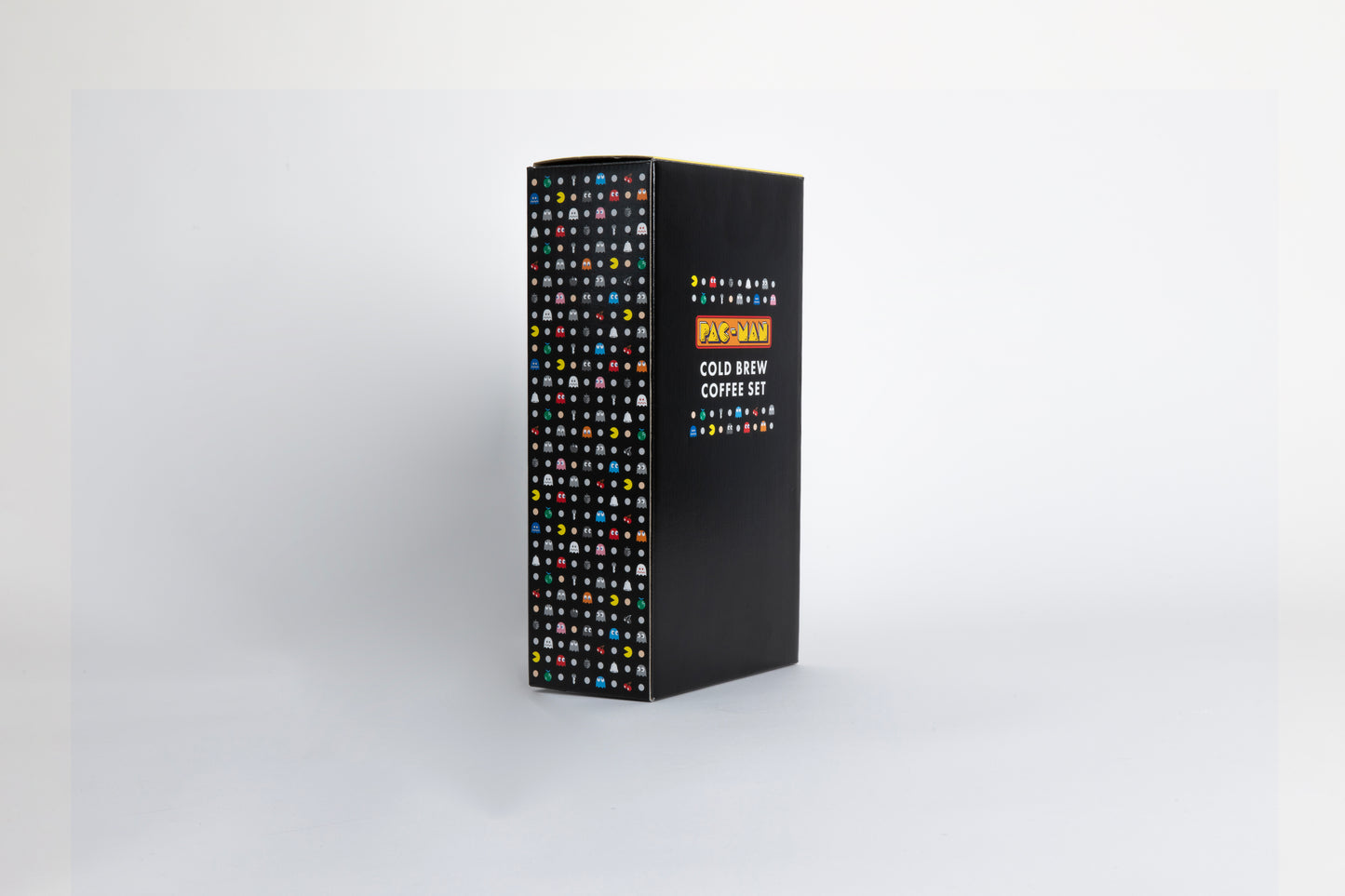 Black color box with Pac-Man logo and characters of colorful ghosts and an yellow, circular figure with a wedge-shaped mouth.