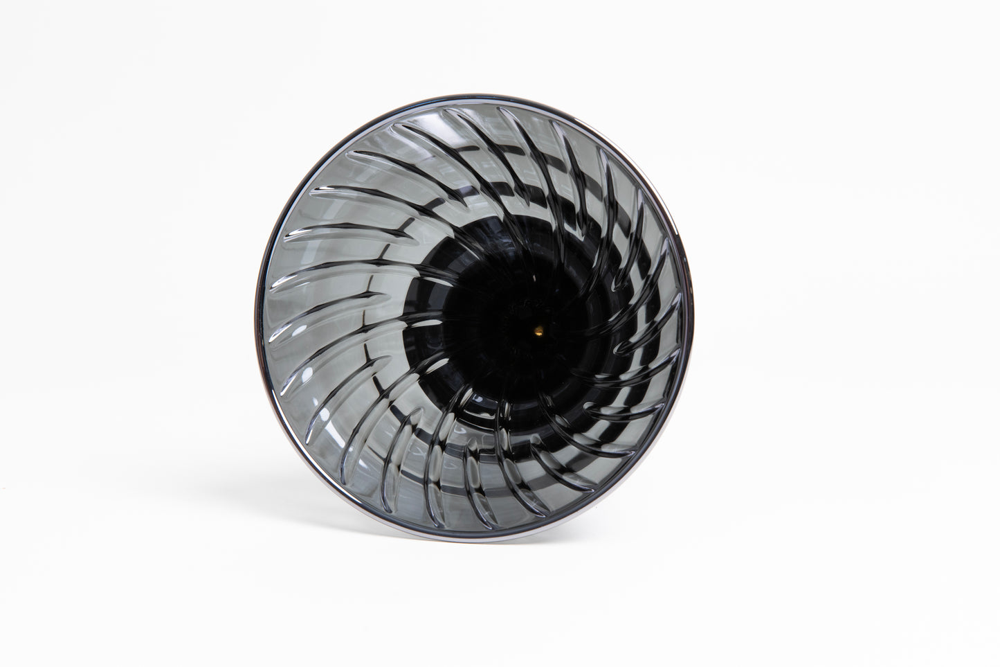 clear black conical ceramic coffee dripper lying on its side showing ribs and drip hole