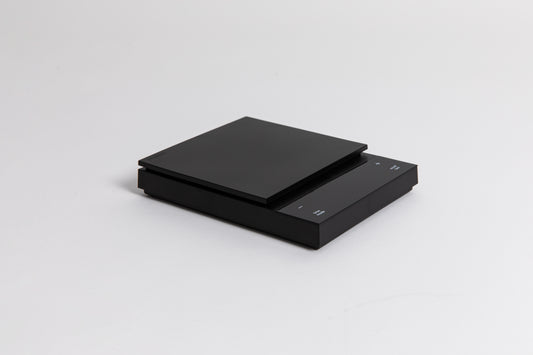 Sleek black digital square scale with a flat surface and clear LED display. set on a white background.