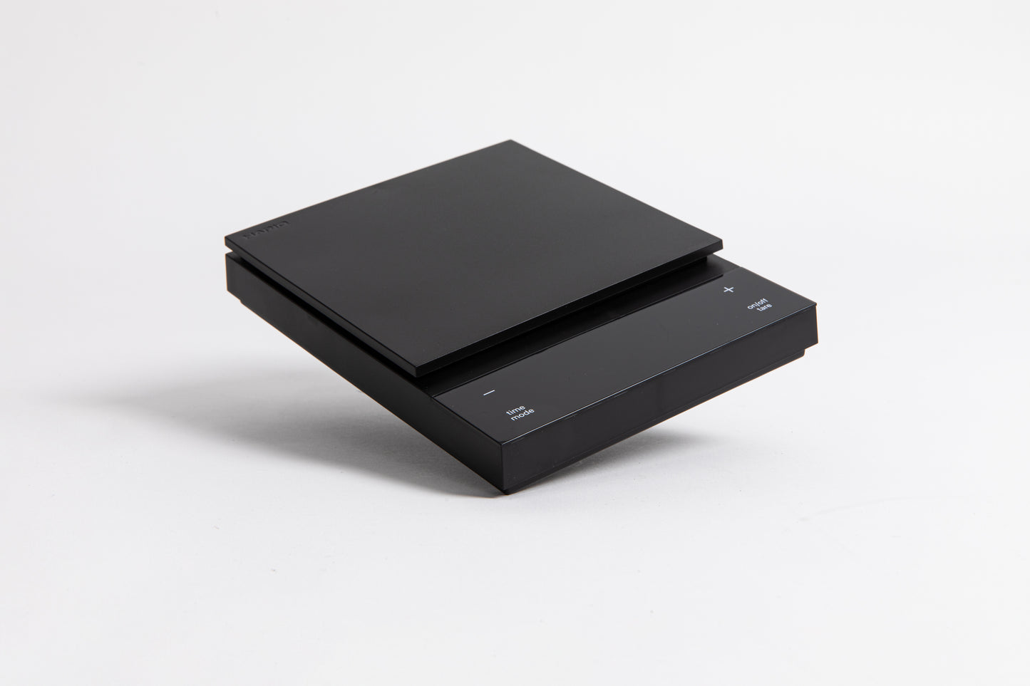 Sleek black digital square scale with a flat surface and clear LED display. set on a white background.