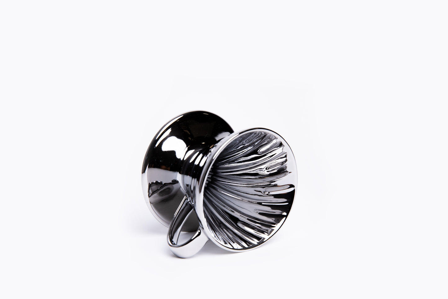 Silver metallic cone coffee dripper with handle with ribbed interior on a white background