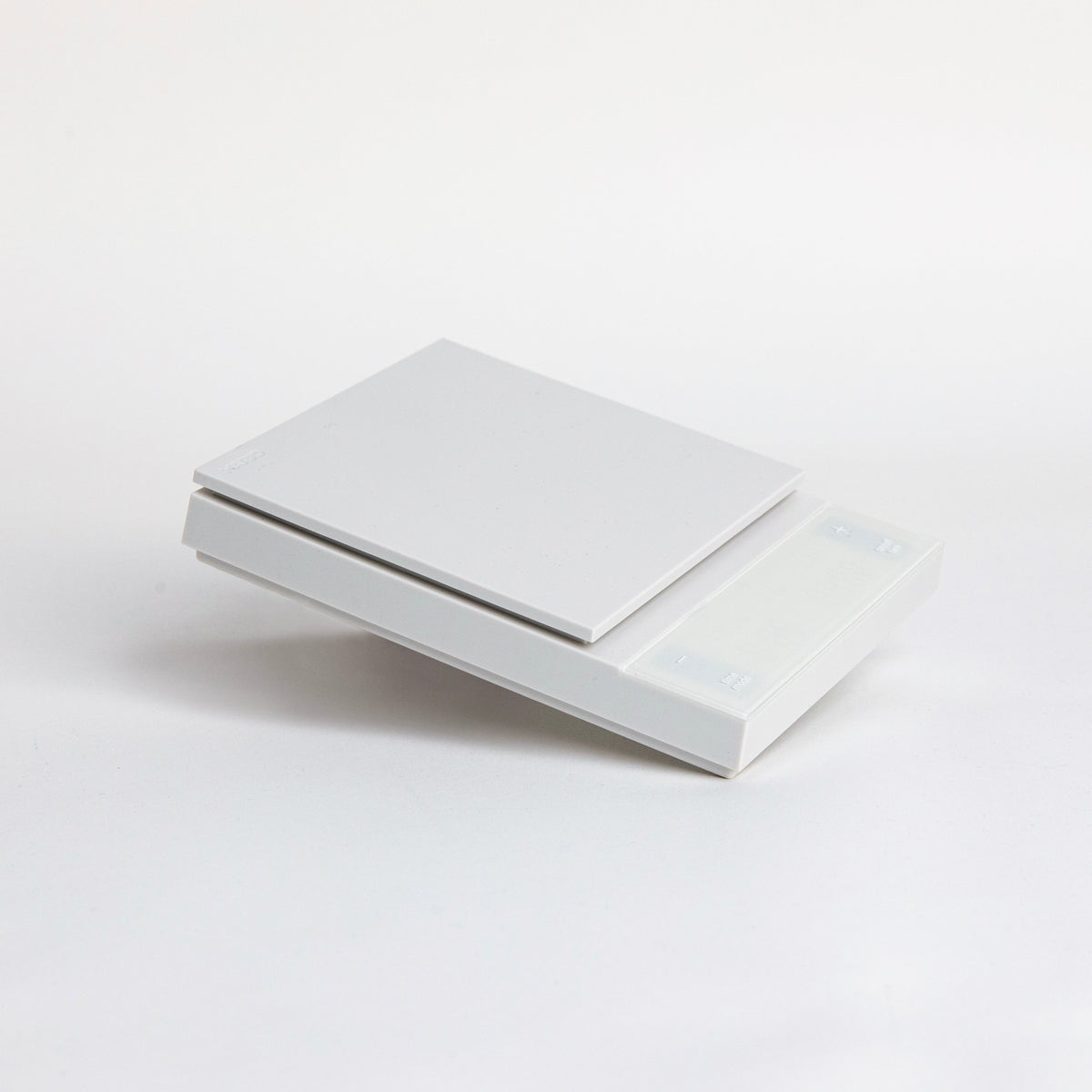 white digital square scale with a flat surface and clear LED display. set on a white background.