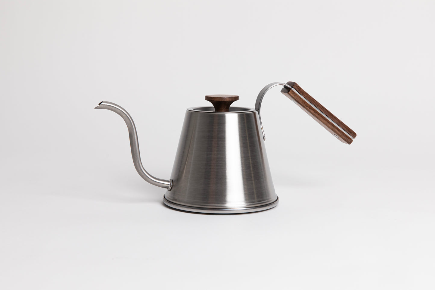 Stainless steel kettle with gooseneck spout, wood handle and flat, wood lid knob set against a white background.