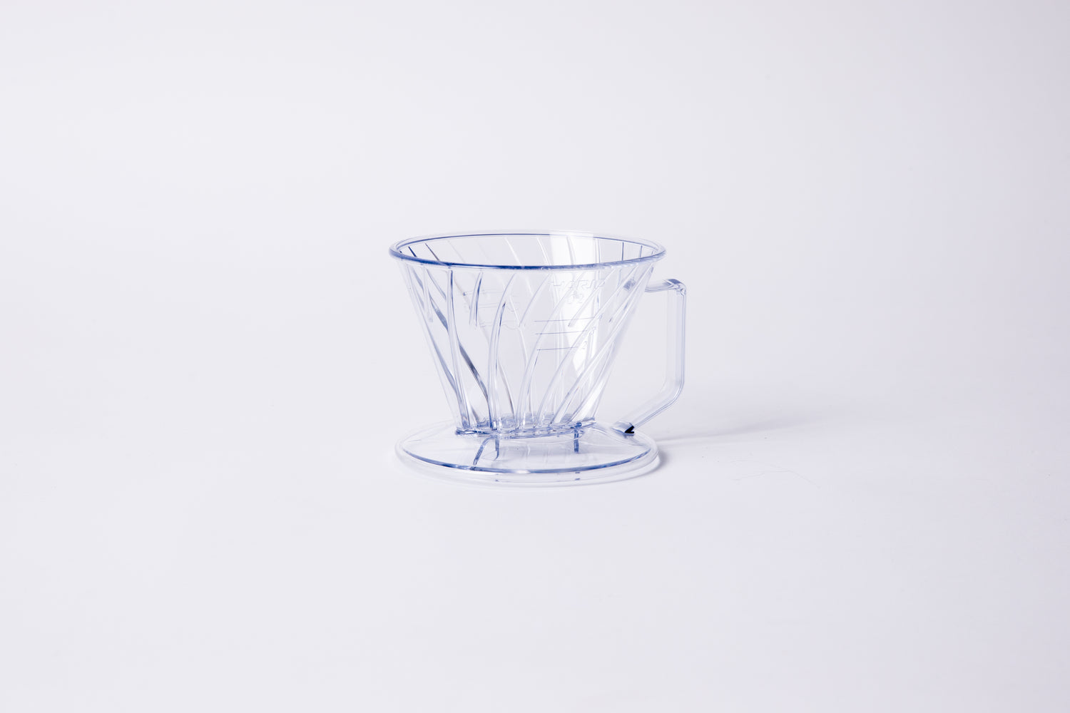 Clear plastic ribbed cone shaped dripper with a flat bottom base and handle. Set on a light gray background