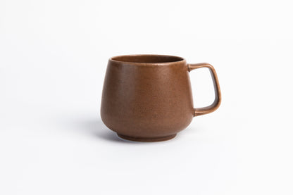 Brown ceramic mug on a white background