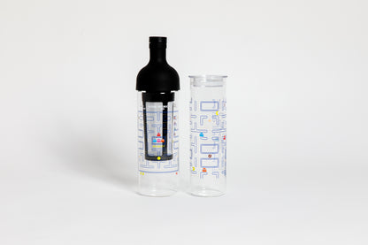 Tall glass container and black nylon mesh coffee filter, with black rubber wine bottle shaped top. Glass decorated with &quot;pac-man&quot; blue maze game with colorful ghosts and an yellow, circular figure with a wedge-shaped mouth.