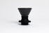 Cone-shaped matte black ceramic dripper seated in a black silicone base with clear plastic push switch on a white background.