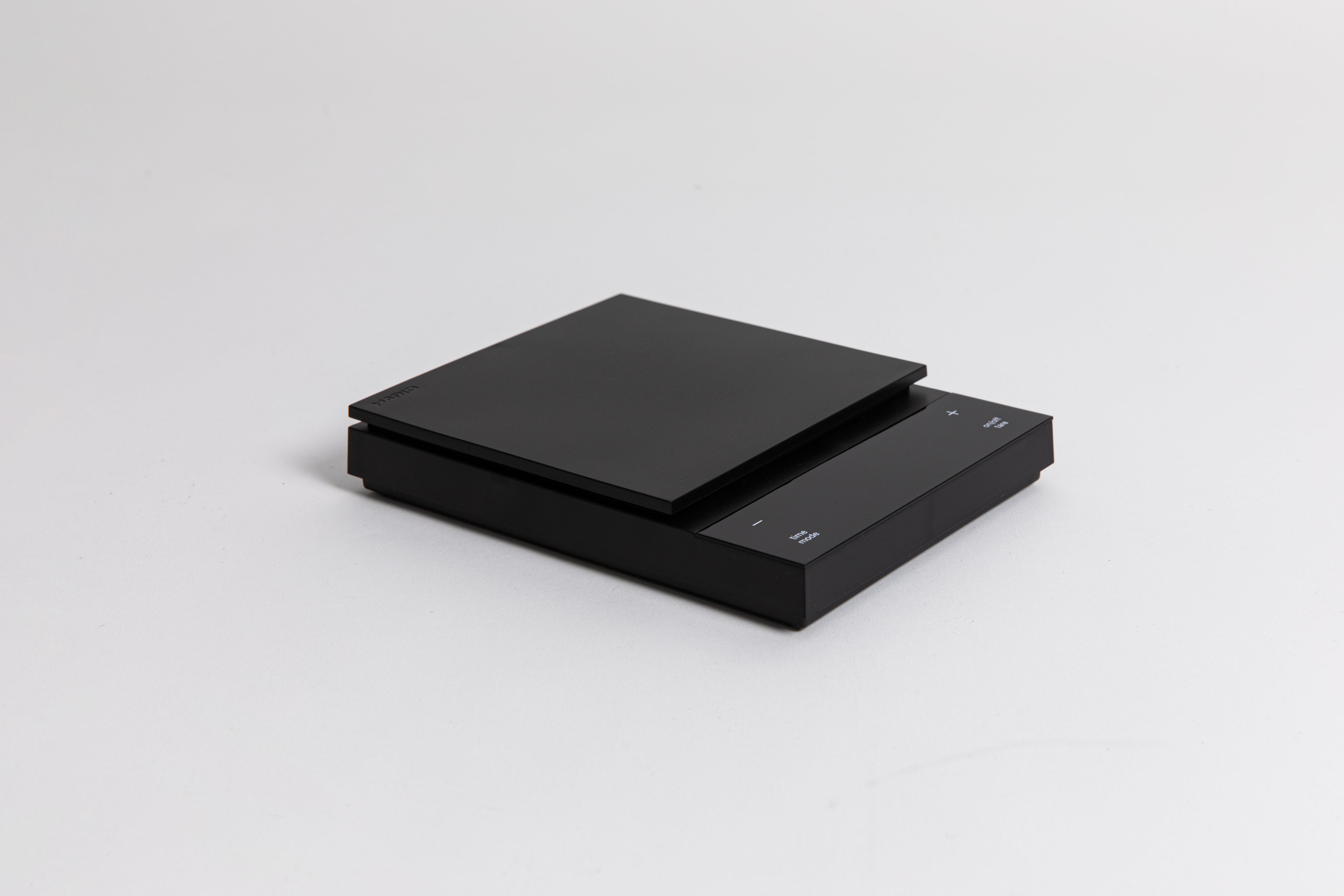 Sleek black digital square scale with a flat surface and clear LED display. set on a white background.