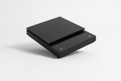 Sleek black digital square scale with a flat surface and clear LED display. set on a white background.