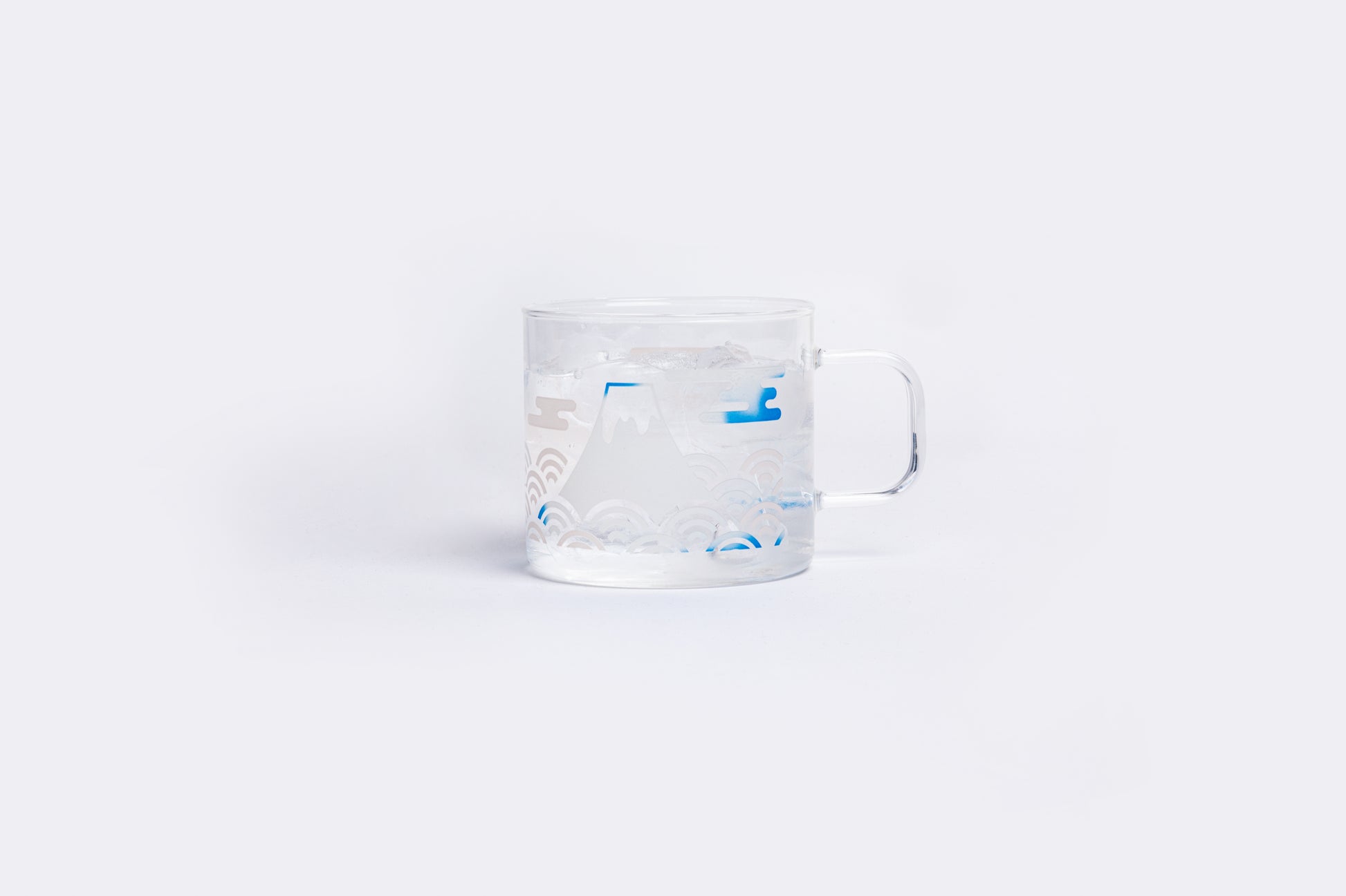 Clear measuring cup with blue markings on a white background