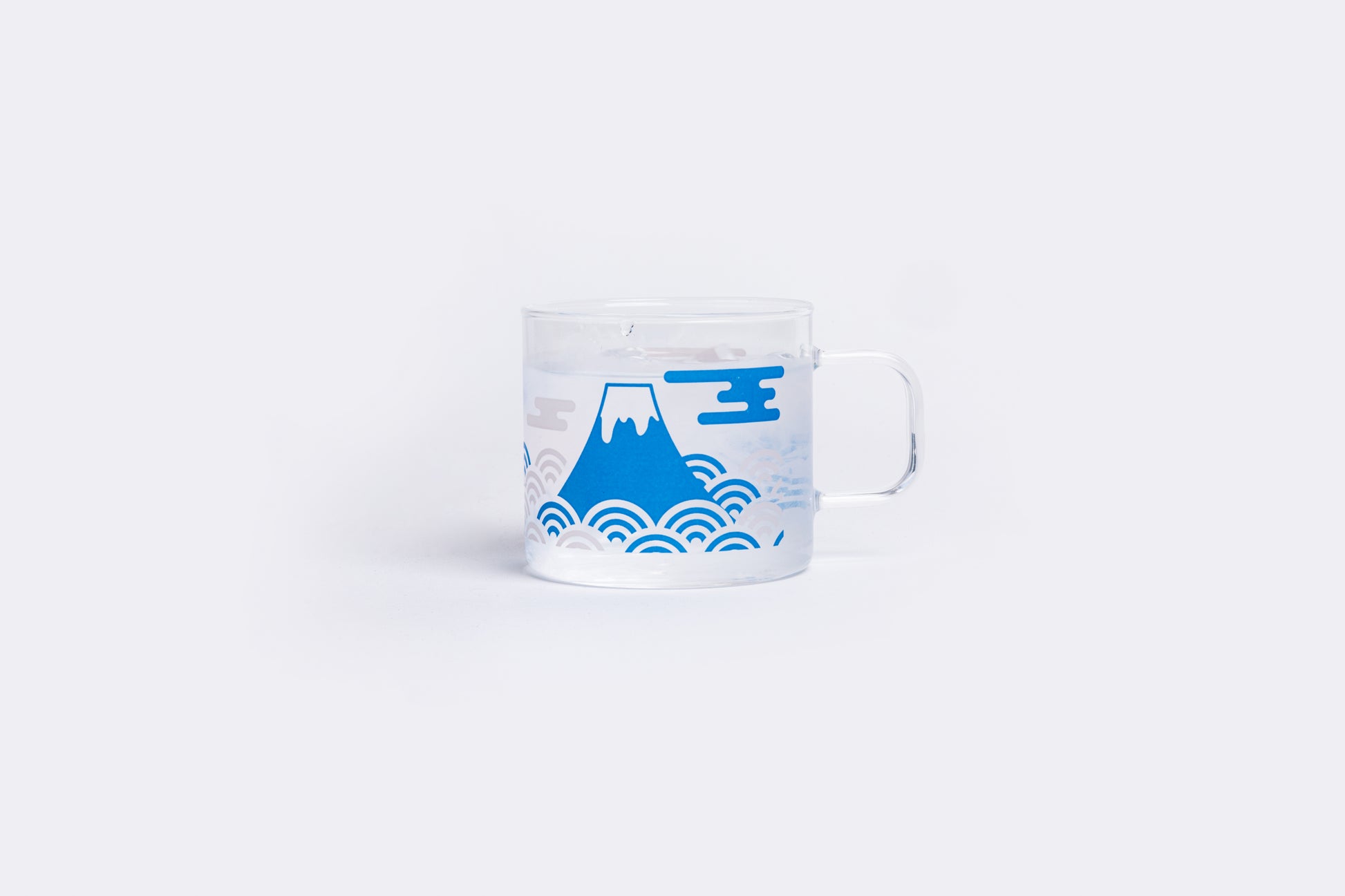White mug with blue mountain and wave design on a white background