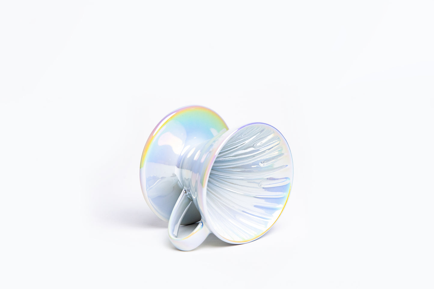 Iridescent cone coffee dripper with handle with ribbed interior on a white background