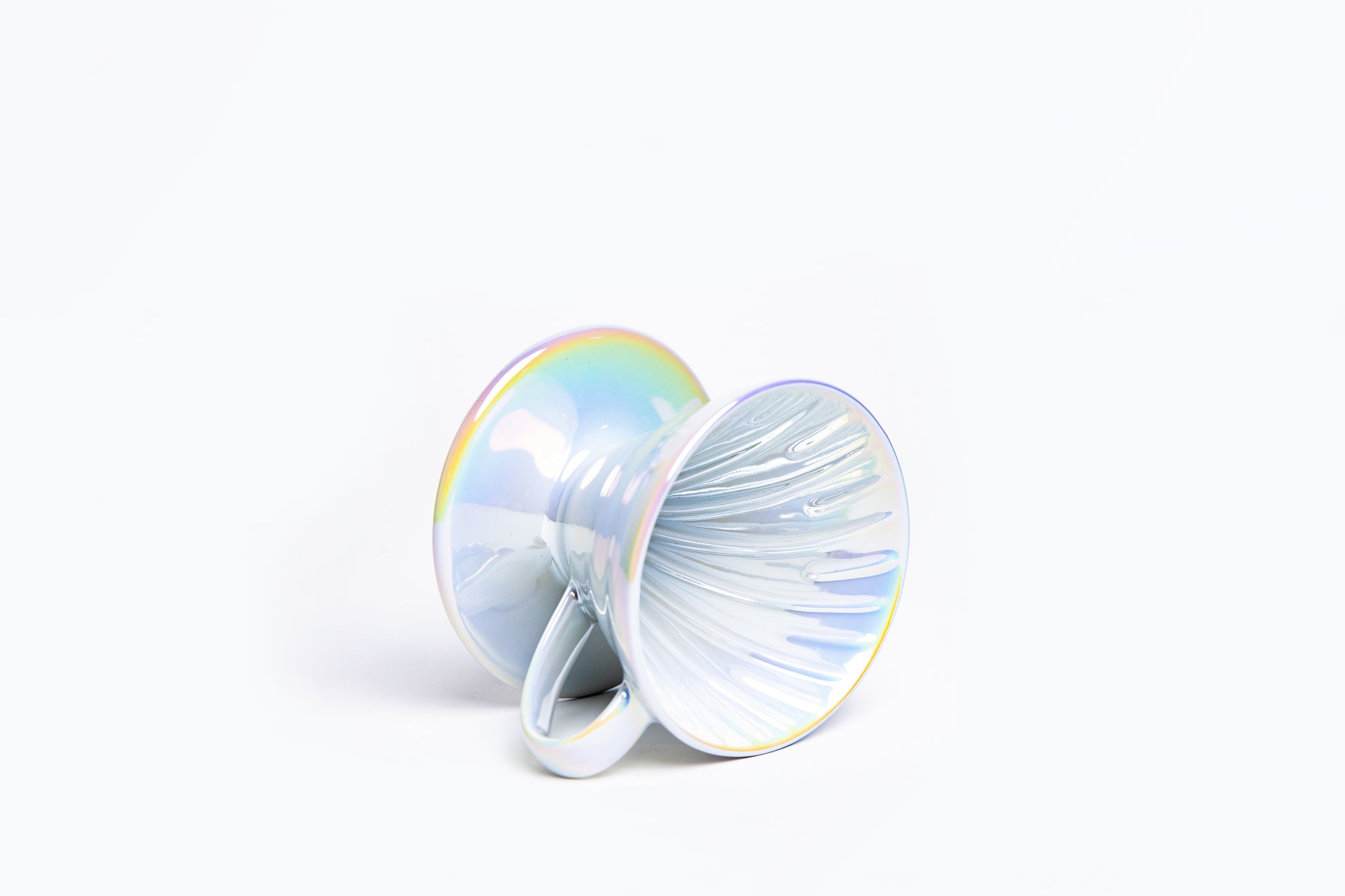 Iridescent cone coffee dripper with handle with ribbed interior on a white background