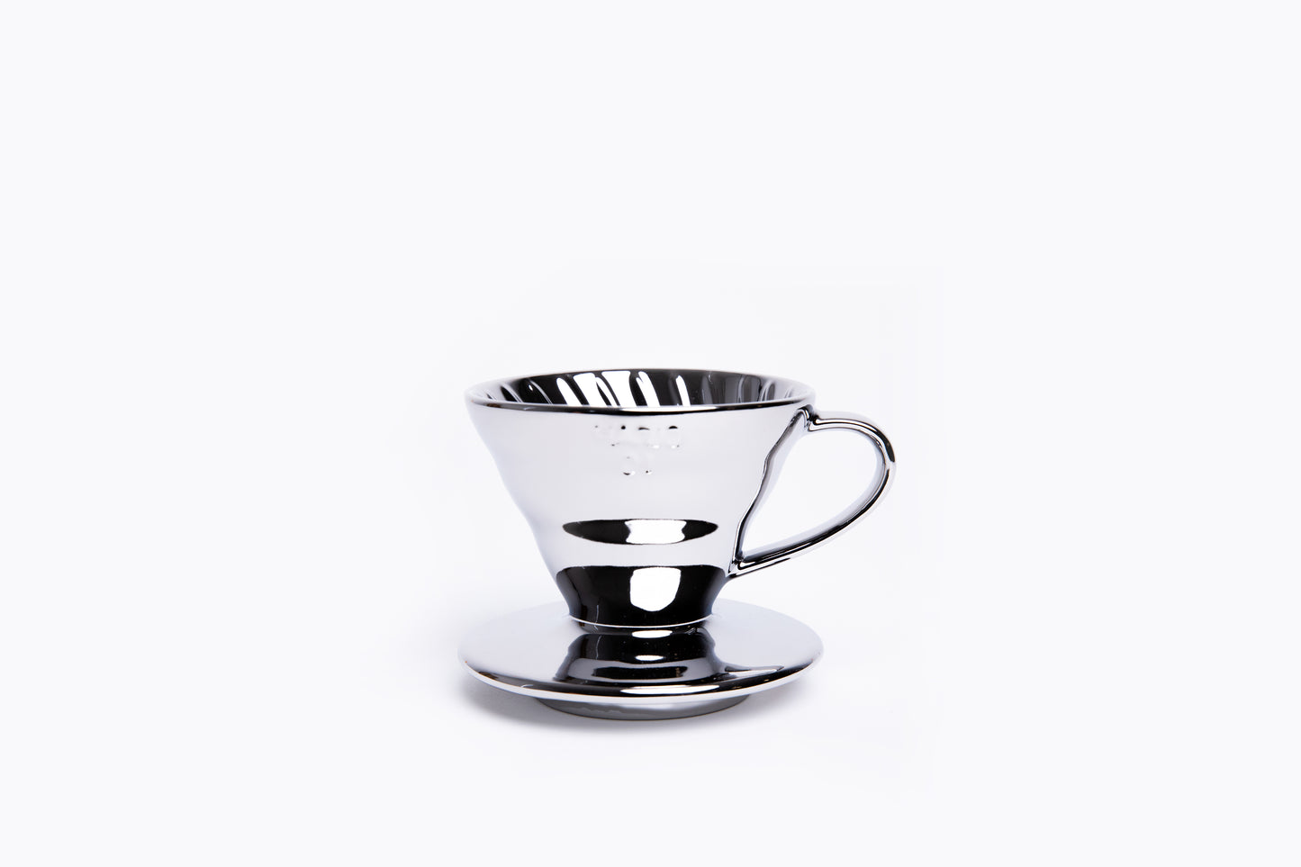 Silver metallic cone coffee dripper with handle on a white background