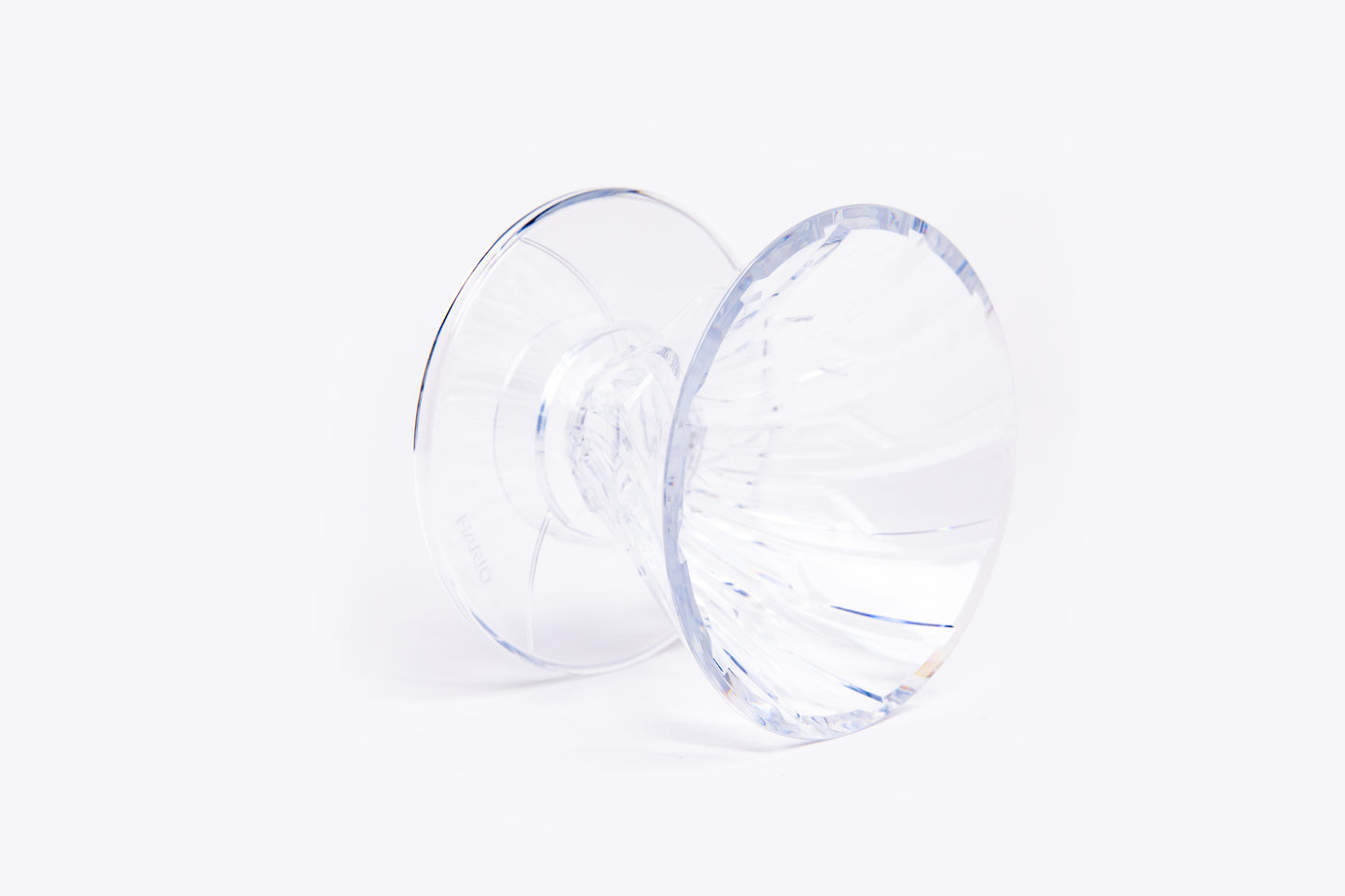 clear plastic cone dripper with interior ribbing on a white background