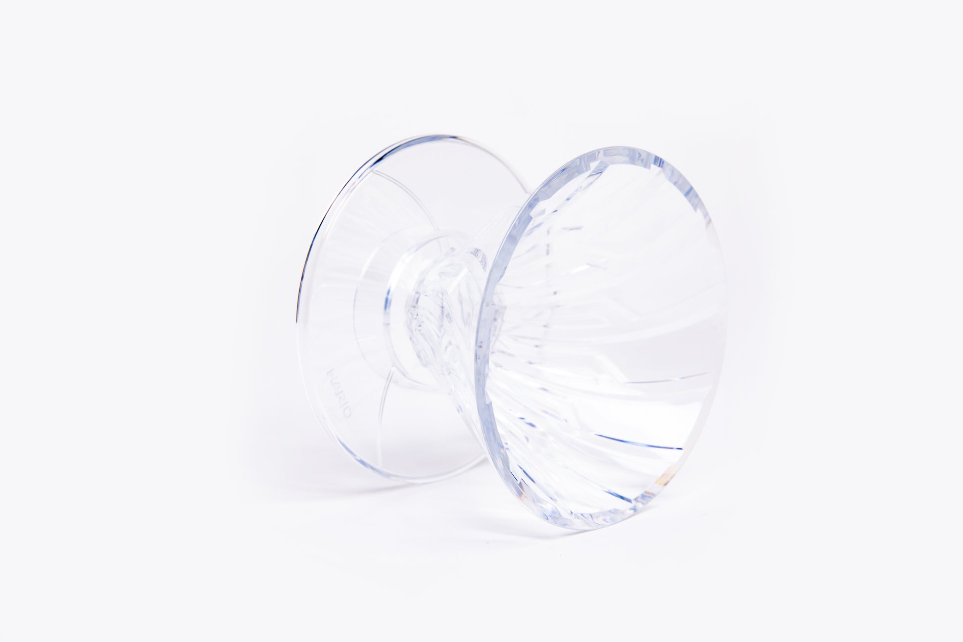 clear plastic cone dripper with interior ribbing on a white background