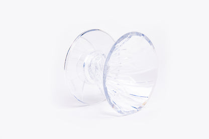 clear plastic cone dripper with interior ribbing on a white background