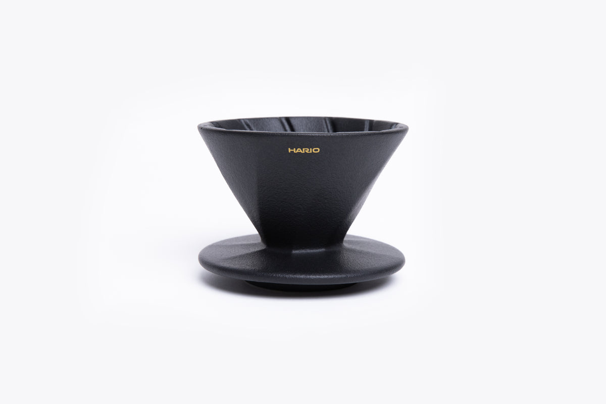 Black coffee dripper with 'Hario' branding on a white background