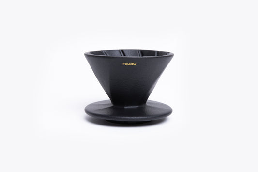 Black coffee dripper with 'Hario' branding on a white background