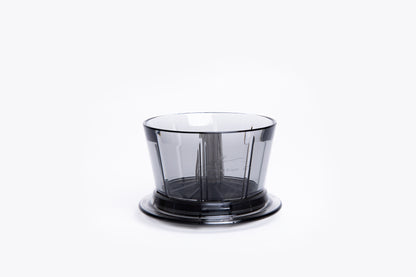 Transparent gray plastic coffee dripper with a flat base on white background