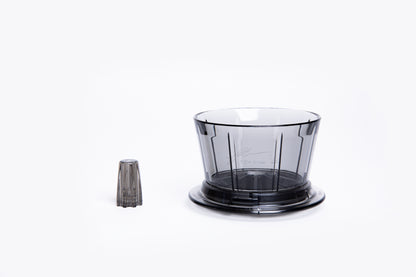 Transparent gray plastic coffee dripper with a flat base with removal center insert on white background