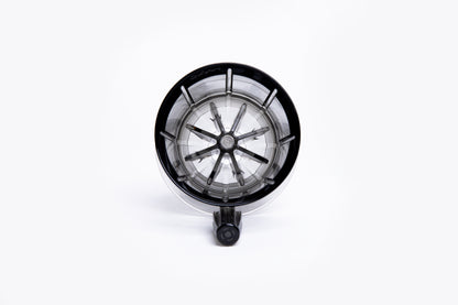 Top view of a clear gray pour-over coffee dripper with internal ridges and a center hole on white background