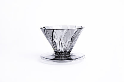 clear gray plastic cone dripper on white background.