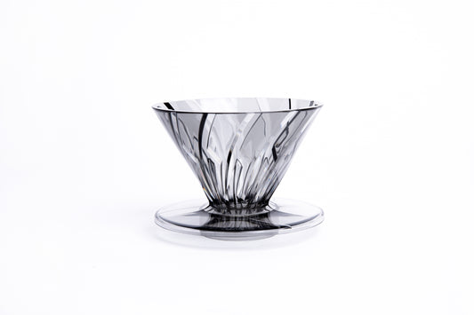 clear gray plastic cone dripper on white background.