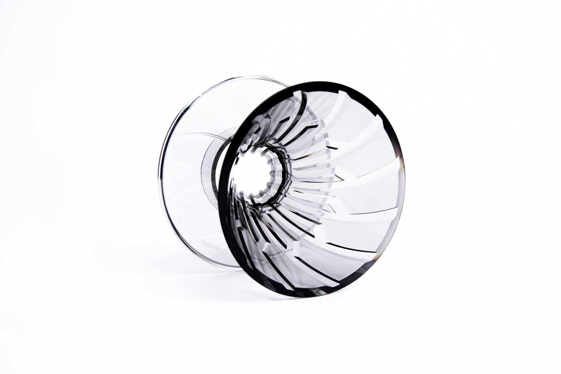 clear gray plastic cone dripper showing interior ribbing on white background.