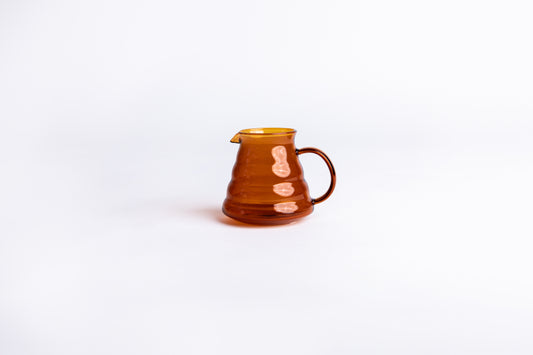 clear amber beehive pitcher on white background