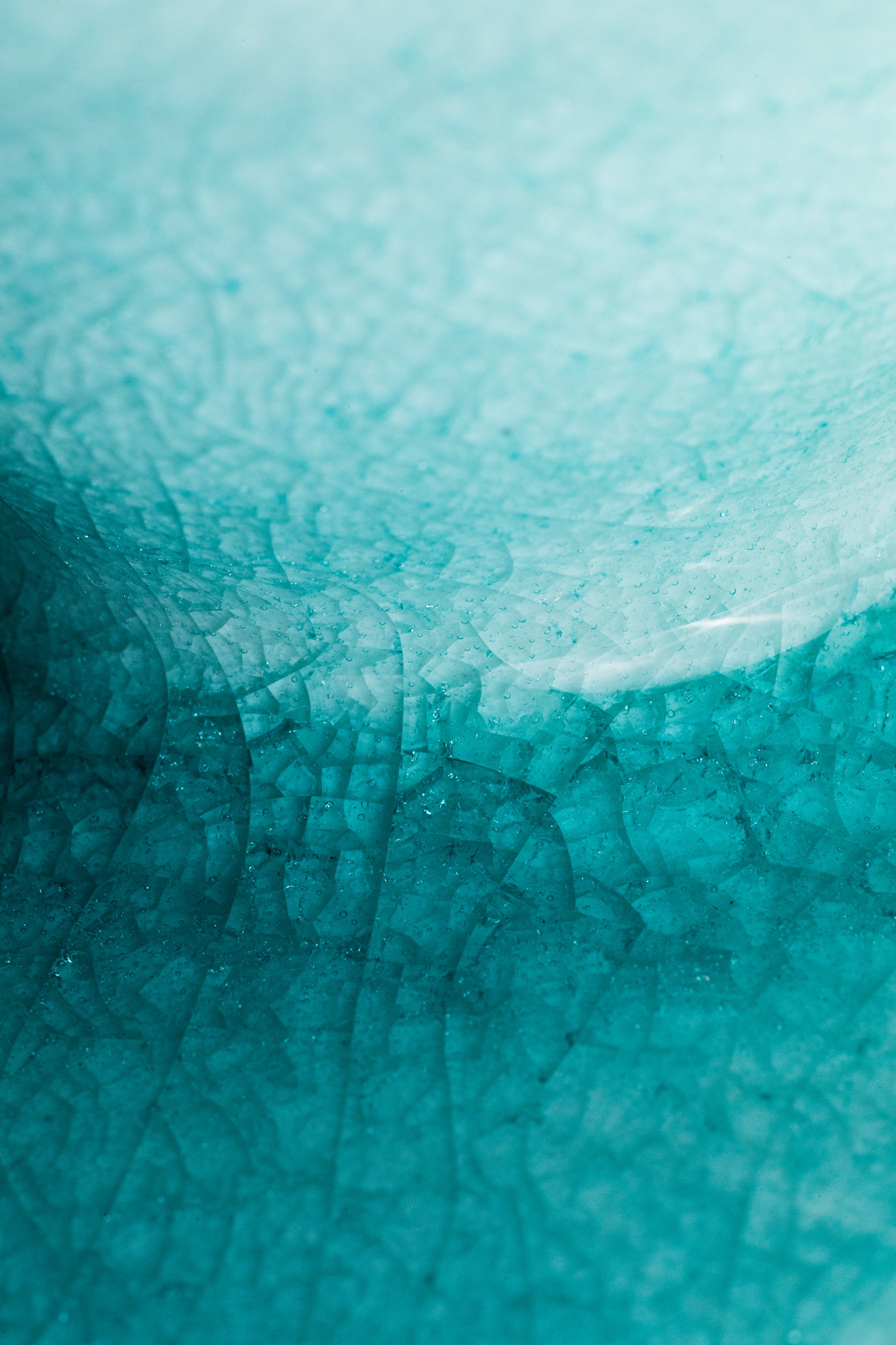 Close-up of a teal cracked glass texture