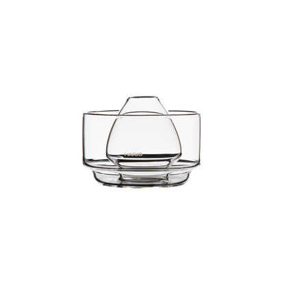 clear glass chasen stand bowl for resting a bamboo matcha whisk and soaking its bristles to soften them, featuring a raised center and rounded glass design. on a white background