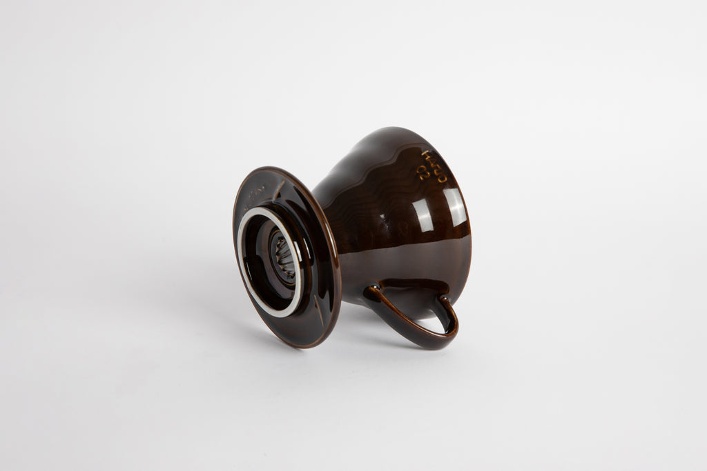 "Saddle" Dark Brown 60 degree cone shaped ceramic coffee dripper with handle and round base. Set on white background