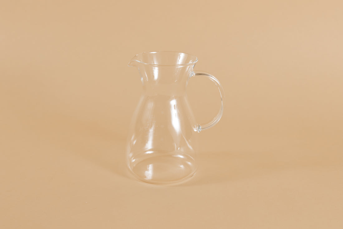 Short all glass coffee decanter with handle and hourglass curve.