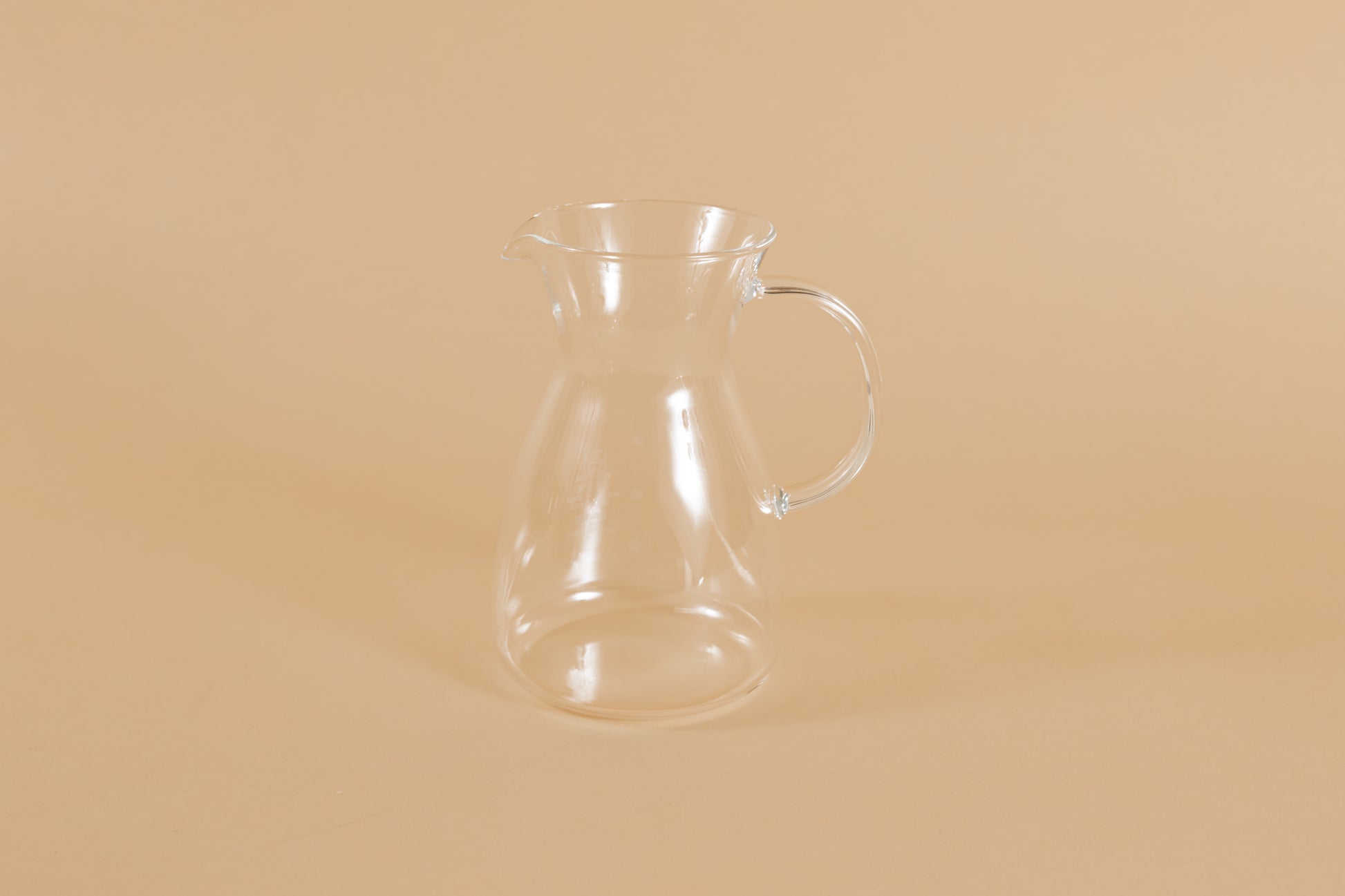 Short all glass coffee decanter with handle and hourglass curve.