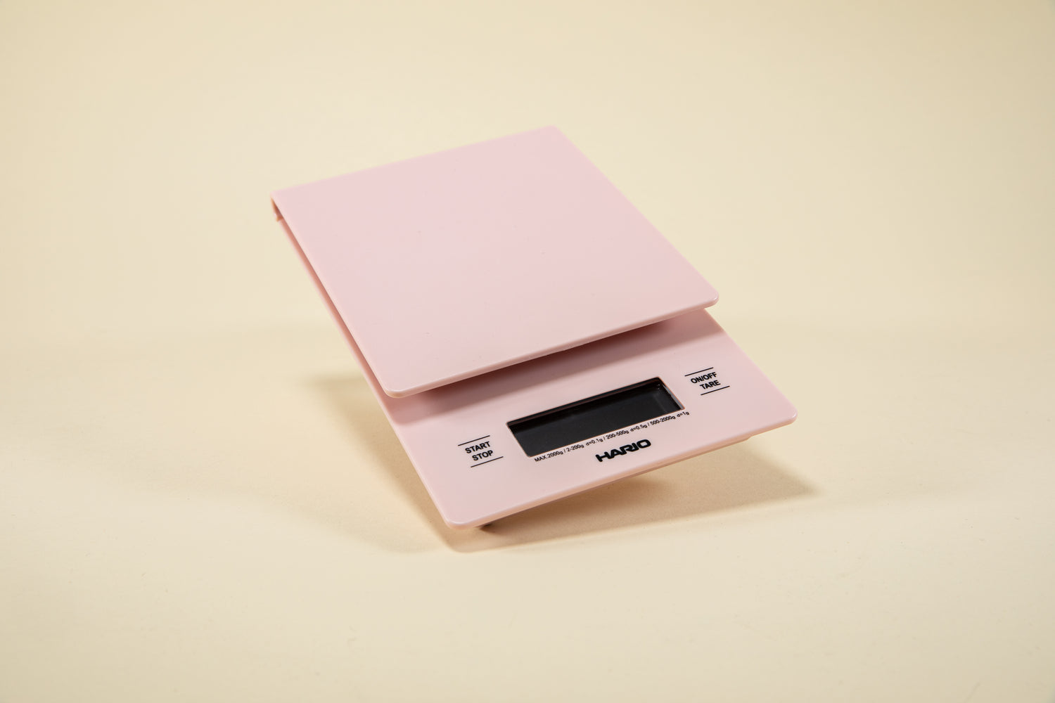 Pink plastic rectangular shaped scale with digital screen and set against a light background.