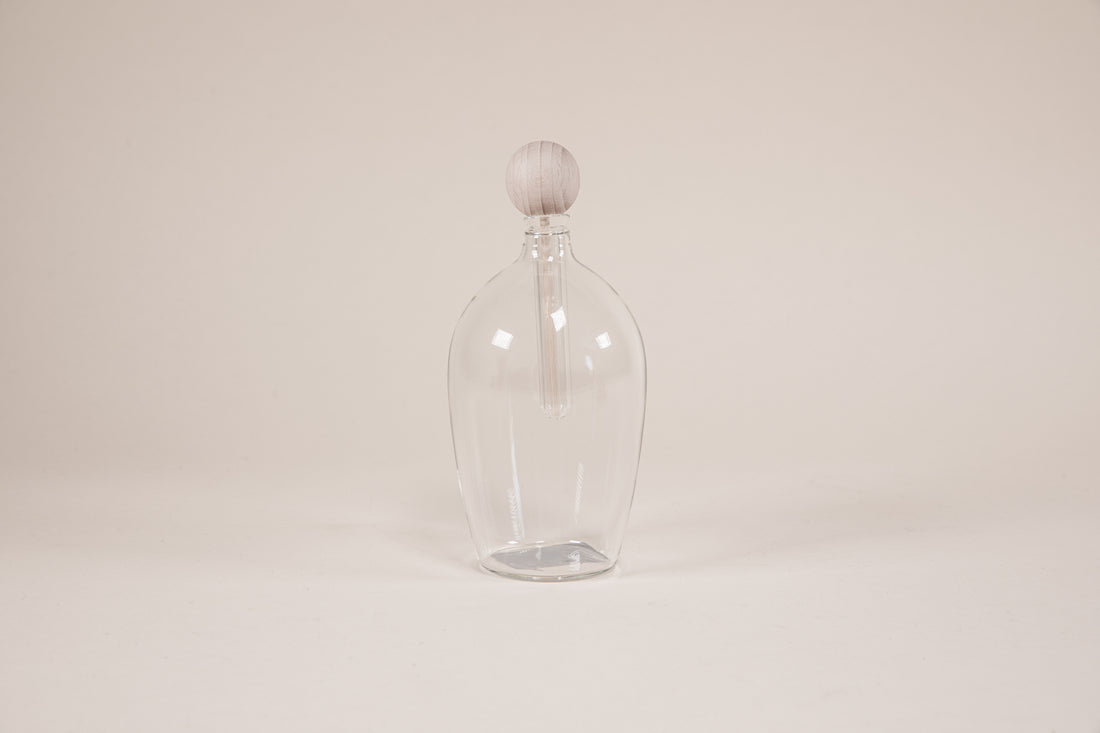 Tuxedo shaped glass diffuser with natural wood insert.