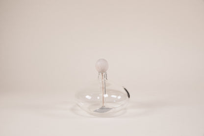 Oval shaped glass diffuser with natural wood wand and round knob.