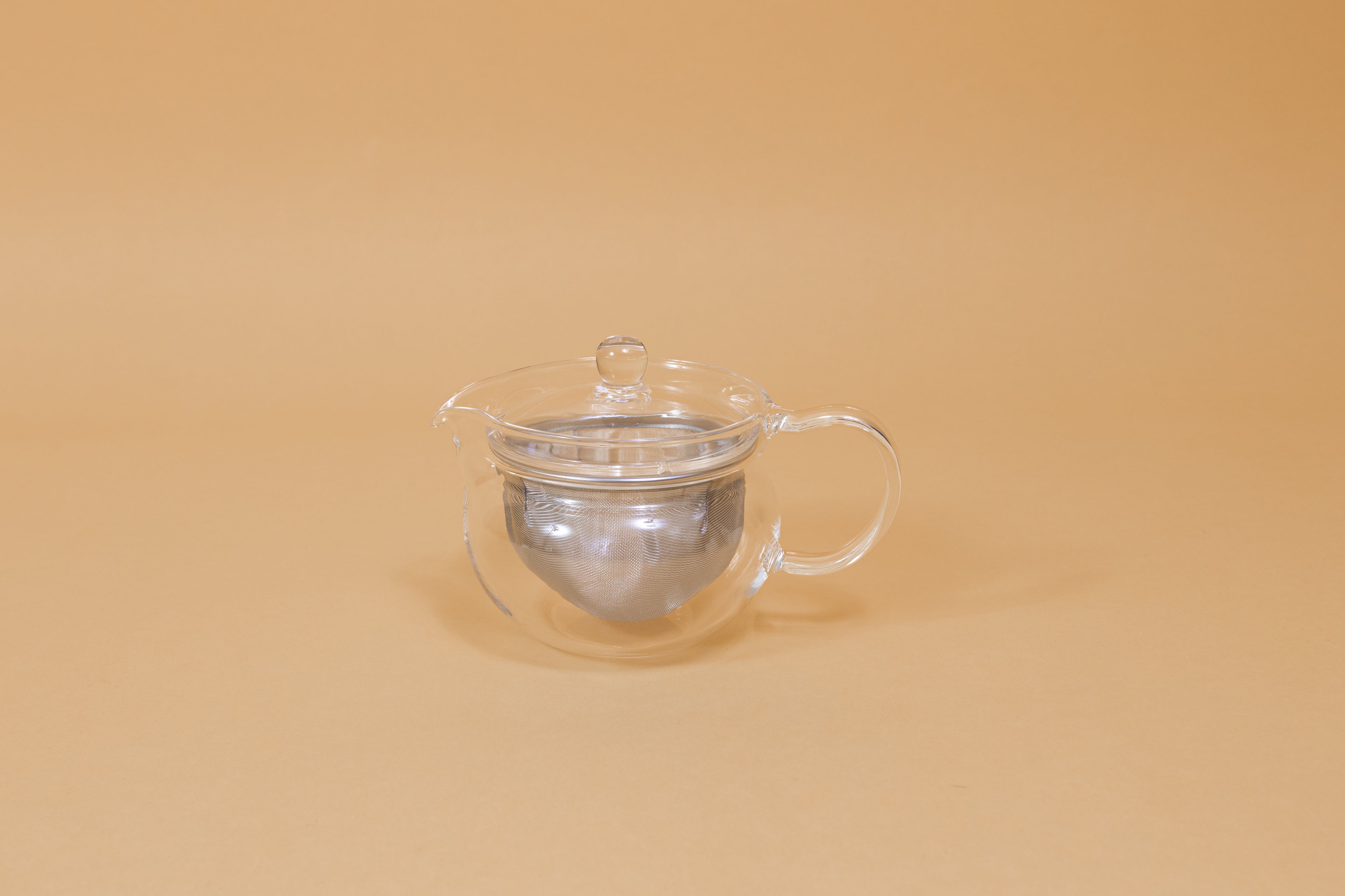 All glass round tea pot with flared top, all glass lid and handle, Metal mesh filter basket insert.