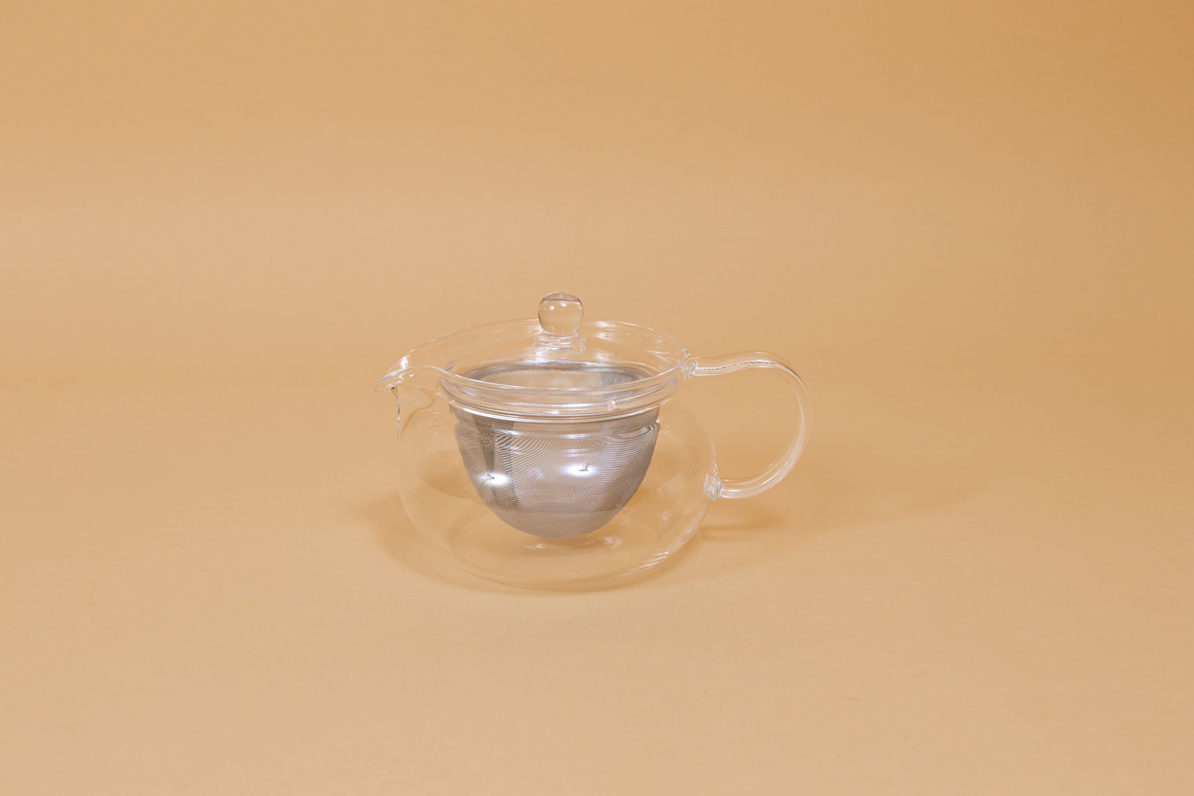 All glass round tea pot with flared top, all glass lid and handle, Metal mesh filter basket insert.