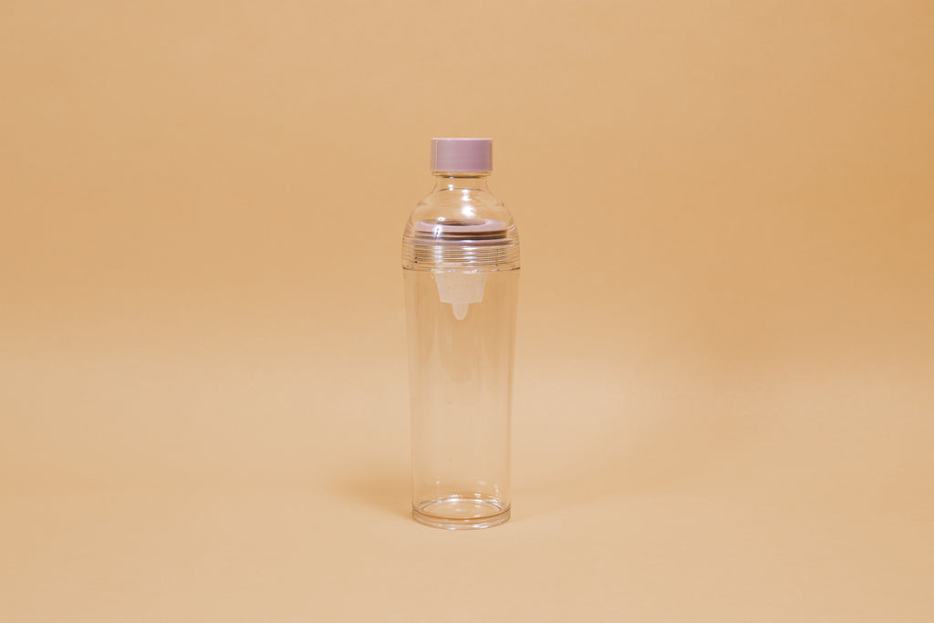 Clear plastic bottle with removable nylon tea strainer and pink plastic cap.