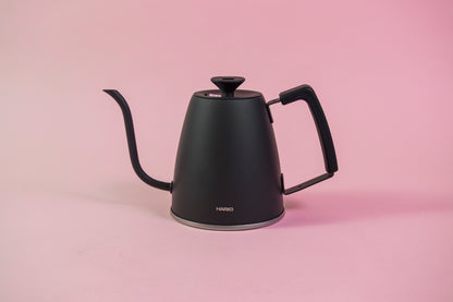 Matte black metal gooseneck kettle with black lid knob and rubber handle cover.