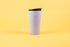 Textured white coffee tumbler with Hario logo and black lid.