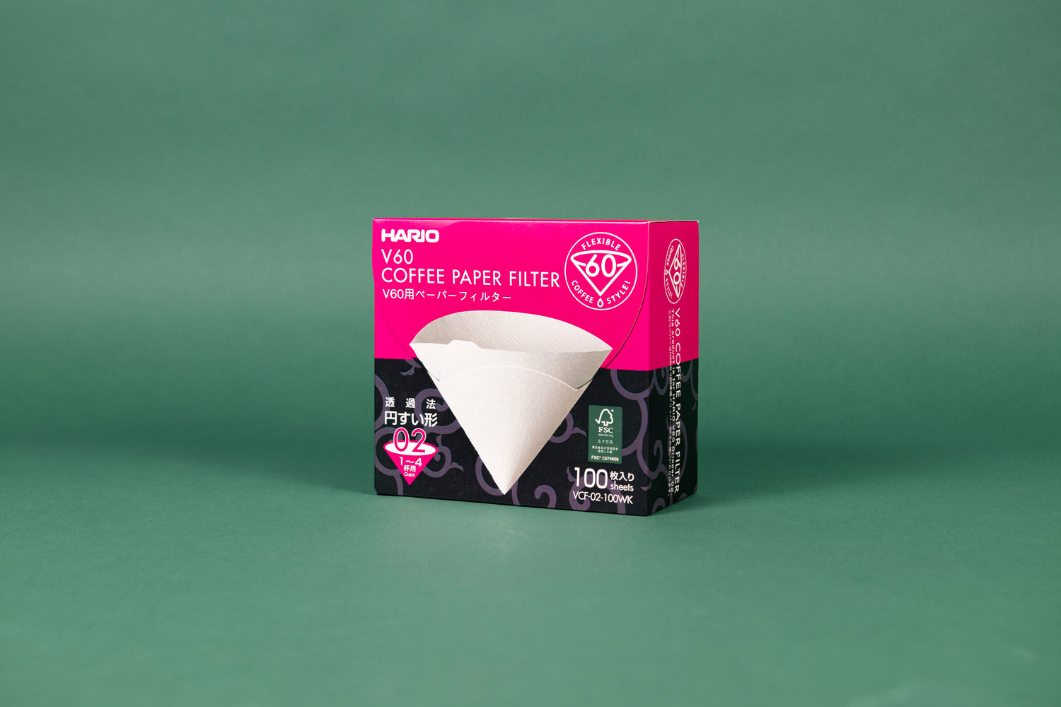 Large pink and black cardboard box with tabbed flip top lid with picture of white paper filter cone on front with white text and set against a green background.
