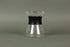 Hourglass shaped glass server with stainless steel wire dripper and black silicone rubber band.