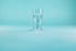 Double wall clear beer glass on a blue background.