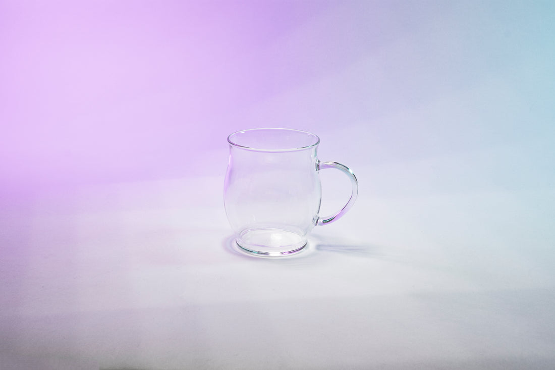 Glass mug with tulip shaped body and glass handle.