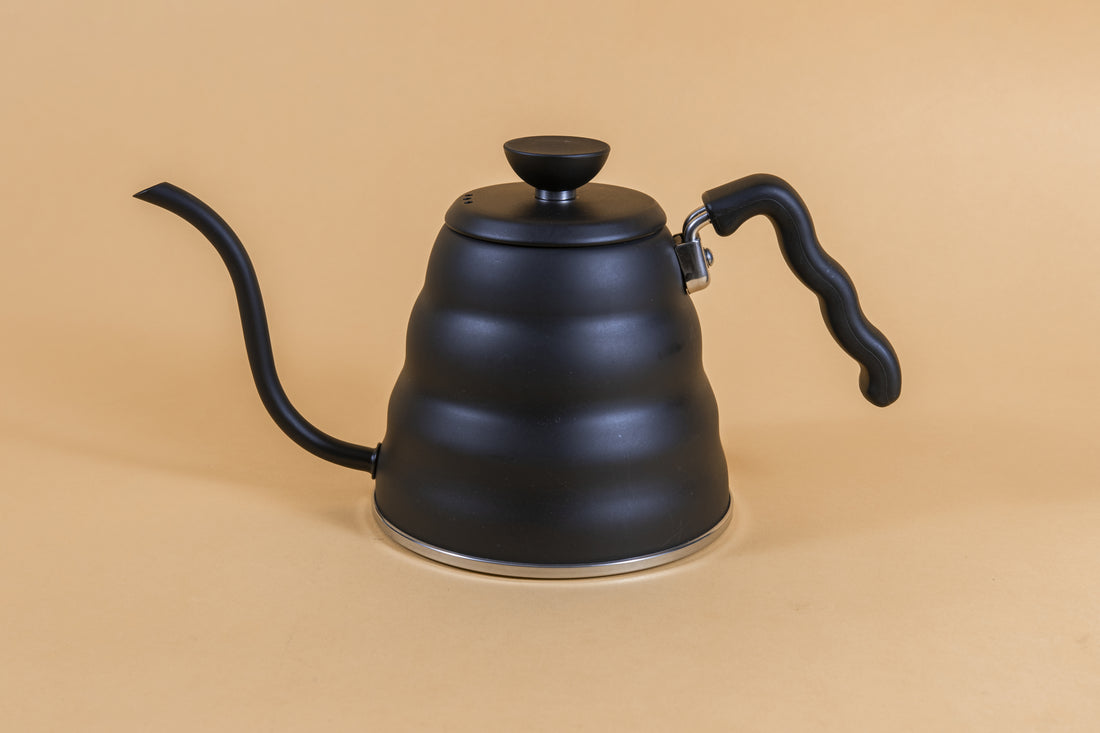 Matte black metal gooseneck kettle and matching lid with plastic knob and black plastic covered handle.