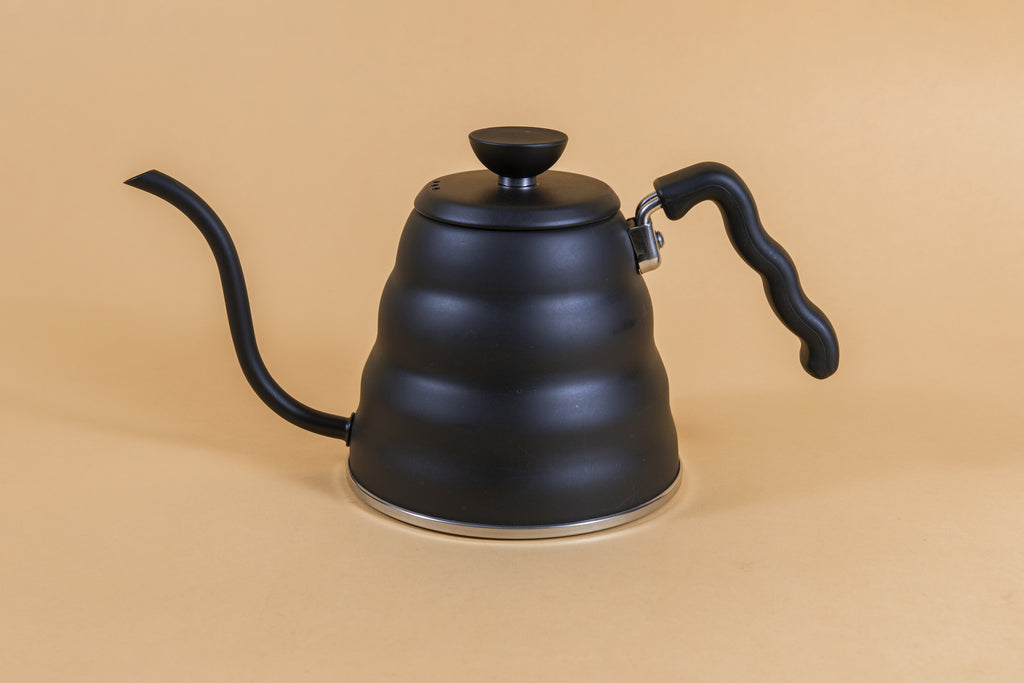 Matte black metal gooseneck kettle and matching lid with plastic knob and black plastic covered handle.